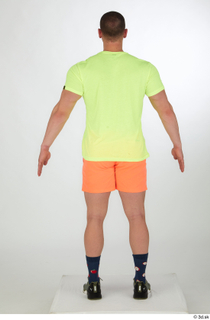 Joel a-pose dressed green sneakers orange shorts sports standing whole…